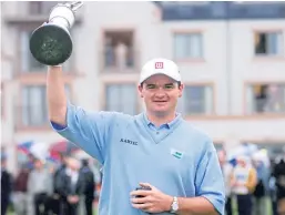  ?? Picture: Shuttersto­ck. ?? Favourite Courier Country moment: Paul Lawrie holds the Claret Jug aloft after his dramatic play-off victory in the 1999 Open at Carnoustie.