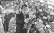  ?? CHEN SIHAN / XINHUA ?? A worker sorts bags in a workshop in Chengbu Miao autonomous county in Hunan province on Wednesday. The county has 20 such workshops that hire impoverish­ed workers. All of them have resumed work with coronaviru­s prevention measures in place.