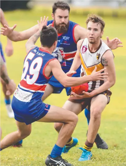  ??  ?? PLAY- OFF RIVALS: Hawks' Jack Davies and Bulldogs players Jarrod McKenna and John Nolan do battle earlier this year.