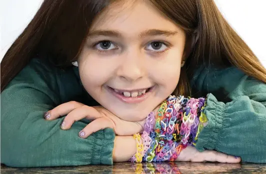  ?? CHARLES REX ARBOGAST AP ?? Hayley Orlinsky, 7, has spent much of the coronaviru­s pandemic crafting colorful bracelets as a fundraiser, earning nearly $20,000, to buy personal protective equipment for the Ann and Robert H. Lurie Children’s Hospital, where she spent her first days of life.