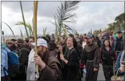  ?? OHAD ZWIGENBERG — THE ASSOCIATED PRESS ?? Christians walk in the Palm Sunday procession on the Mount of Olives in east Jerusalem on Sunday.