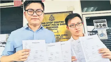  ??  ?? Wong (left) and Sim hold up the six police reports lodged at the One-Stop Centre yesterday.