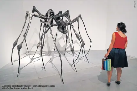  ??  ?? A journalist looks at Spider Couple by French artist Louise Bourgeois at the Tel Aviv Museum of Art on Sept 6.