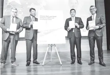  ??  ?? Azmin Ali (second right); CIMB Group group chief executive officer Tengku Datuk Sri Zafrul Aziz (right), Munir (second left) and Professor Christophe­r Coker, director of LSE IDEAS at the launch of “China’s Belt and Road Initiative (BRI) and Southeast Asia” report in Kuala Lumpur on Tuesday.