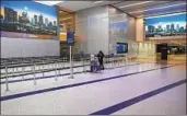  ?? Brian van der Brug Los Angeles Times ?? AN AIRPORT WORKER stands at a TSA line at Los Angeles Internatio­nal Airport on March 14.