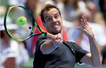  ?? AFP ?? France’s Richard Gasquet returns to Rafael Nadal of Spain in their men’s singles match at the Kooyong Classic tennis tournament in Melbourne on Tuesday. Gasquet won 6- 4, 7- 5. —