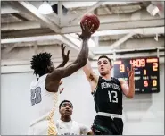  ?? JAMES BEAVER — FOR MEDIANEWS GROUP ?? Pennridge’s Colin Post (13) puts up a running jump shot over Roman Catholic’s Jalen Duren (23) last season. Area high school teams can resume activities Monday as Gov. Tom Wolf is allowing recent COVID-19 restrictio­ns to expire.