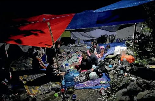  ?? AP ?? Earthquake survivors rest under a makeshift tent in Cianjur, West Java, Indonesia.