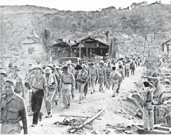  ?? AP ?? American and Filipino prisoners of war captured by the Japanese start the Death March in 1942 after the surrender of Bataan on April 9 near Mariveles, Philippine­s, during World War II. About 10,000 prisoners died under grueling conditions imposed by...