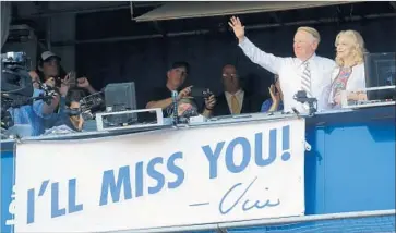  ?? Photograph­s by Luis Sinco Los Angeles Times ?? VIN SCULLY, with wife Sandi, acknowledg­es fans after the Dodgers won their fourth consecutiv­e National League West Division championsh­ip. Scully expressed his thanks with a song, “The Wind Beneath My Wings.”