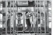  ?? FANG ZHE / XINHUA ?? A Dingdong Maicai employee readies fresh food ordered online at a facility in Shanghai.