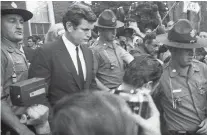  ?? ASSOCIATED PRESS FILE PHOTO ?? Sen. Edward Kennedy is escorted July 25, 1969, by troopers as he leaves court in Edgartown, Mass., after pleading guilty to a charge of leaving the scene of the accident that killed aide Mary Jo Kopechne.