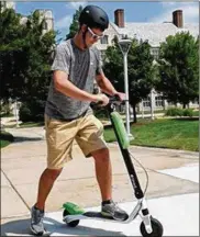  ?? JETTA FRASER / THE (TOLEDO) BLADE ?? Gavin Hoying, 21, a nursing major from Russia, Ohio, tests a Lime-S scooter on Thursday on the University of Toledo campus.