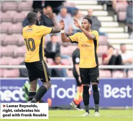  ??  ?? > Lamar Reynolds, right, celebrates his goal with Frank Nouble
