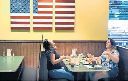  ?? JOE BURBANK/ORLANDO SENTINEL ?? Patrons enjoy a meal at the Metro Diner Express at its UCF location on University Boulevard on Wednesday. Metro Diner Express is an example of how restaurant­s are changing their designs to accommodat­e contactles­s and carryout business as a result of the coronaviru­s pandemic.