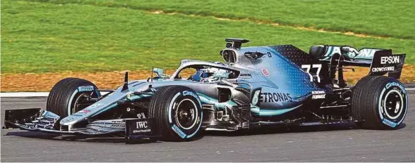  ??  ?? Valtteri Bottas puts Mercedes AMG Petronas' new car, the W10, through its paces at the Silverston­e circuit yesterday.