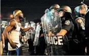  ?? JEFF ROBERSON/AP ?? A protester yells at police just before violence broke out Saturday in University City, Mo.