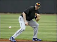  ?? THE ASSOCIATED PRESS ?? In this file photo, second baseman Neil Walker fields a ground ball during infield drills before a scrimmage game in Bradenton, Fla.