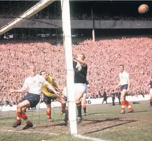  ??  ?? Wolves’ Ron Flowers, left, playing for England against Scotland in 1962, at Hampden. John Reades hits the crossbar with keeper Ron Springett beaten. Denis Law is at the post