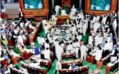  ?? — PTI ?? Opposition members protest during the ongoing Budget Session of Parliament at the Lok Sabha in New Delhi on Monday.