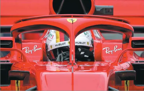  ?? ALBERT GEA / REUTERS ?? Ferrari’s Sebastian Vettel looks through the ‘halo’ during testing in Montmelo, Spain, on March 8. The Formula One season starts this weekend in Melbourne.