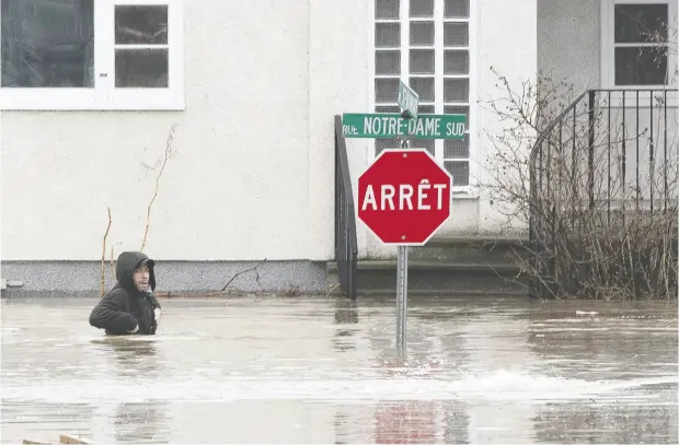  ?? Jacques Boisinot / THE CANADIAN PRESS ?? More than 600 square kilometres of land were affected by flooding, according to maps created by Statistics Canada.