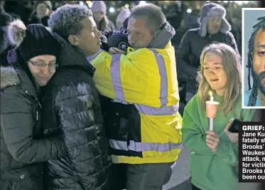  ?? ?? GRIEF: The family of Jane Kulich, one of six fatally struck by Darrell Brooks’ SUV in the Waukesha parade attack, mourns at a vigil for victims last week. Brooks (above) had been out on $1,000 bail.