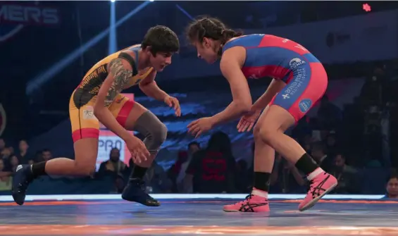  ??  ?? Veer Marathas’ Ritu Phogat ( left) in action against Vinesh Phogat of UP Dangal in their Pro Wrestling League bout at the Siri Fort Sports Complex in New Delhi on Friday. Dangal won 4- 3.