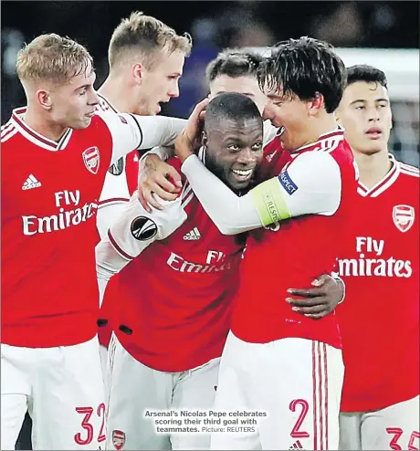  ?? Picture: REUTERS ?? Arsenal’s Nicolas Pepe celebrates scoring their third goal with teammates.