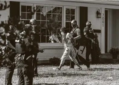  ?? Mary Ann Gerth / Associated Press ?? Kentucky Attorney General Daniel Cameron's home was taken over by dozens of protesters chanting Breonna Taylor’s name, and calling for immediate justice for her killing by Louisville police, who were serving a search warrant. Cameron’s office is reviewing the case, but does not have a timeline for its conclusion.