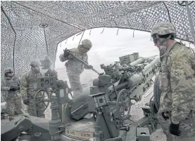  ??  ?? CALLING SHOTS: Soldiers train on a howlitzer during a live-fire exercise at Fort Sill, Oklahoma. The Army’s planned Futures Command wants to make howitzers more effective from afar. NEW VISION: Sgt 1st Class Shane Webb looks out of a virtual window in...