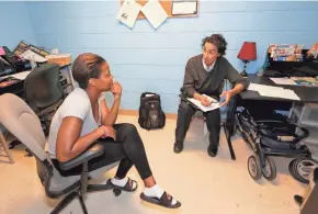  ?? MIKE DE SISTI / MILWAUKEE JOURNAL SENTINEL ?? James Dimitri Topitzes, a University of Wisconsin-Milwaukee trauma researcher and public health professor, talks with Genette Ford at the COA Goldin Center in the hard-hit Amani neighborho­od.