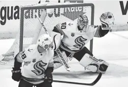  ?? JIM RASSOL/AP ?? Kraken goaltender Chris Driedger makes a glove save against the Panthers during the first period Saturday in Sunrise, Fla.