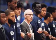  ?? Jessica Hill / Associated Press ?? UConn coach Dan Hurley stands with his team during the national anthem before a Nov. 13 game.