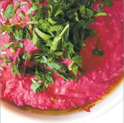  ?? PHOTO COURTESY PARTIES THAT COOK ?? This silky hummus gets its flavor from lemon juice and its pink color from a roasted beet that is blended with the chickpeas.