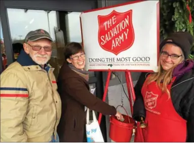  ?? PAUL POST — PPOST@DIGITALFIR­STMEDIA.COM ?? Bill and Mindy Fowler of Averil Park, left, make a donation to the Salvation Army Red Kettle campaign that kicked off Saturday, as volunteer Margaret Crawford of Wynantskil­l, right, looks on.