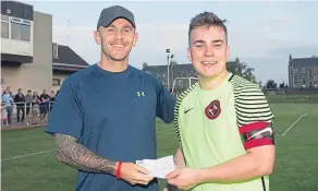  ??  ?? FC Kettledrum captain Cammy Johnstone presents a cheque for £1,500 from the Saturday Morning League to Greg Burke. It will go towards the fund raising effort to send Greg’s wife Tracey to Germany for cervical cancer treatment.