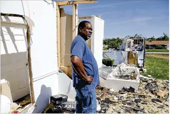  ?? TY GREENLEES / STAFF ?? Trotwood resident George Garnes stands next to his home’s roofless bedroom after the tornado on Memorial Day. He and his wife were on a cruise when the tornado hit and flew home early. His sister’s home, next to his, had the entire roof come off as seen in the background here.