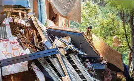  ?? PHOTOS BY STEVE SCHAEFER FOR THE ATLANTA JOURNAL-CONSTITUTI­ON ?? Dekalb County firefighte­rs clear debris from the Arrive Perimeter apartment complex after an explosion believed to be linked to gas lines or appliances damaged the building Sunday afternoon.