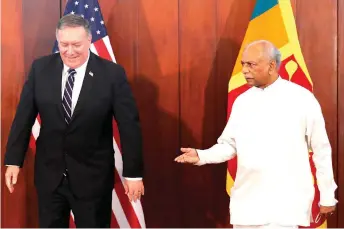  ?? Photo — AFP ?? Sri Lankan Foreign Minister Dinesh Gunawarden­a (right) gestures to Pompeo before their meeting in Colombo.