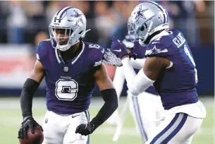  ?? RON JENKINS/GETTY ?? Dallas Cowboys safety Jayron Kearse, right, celebrates with teammate Donovan Wilson, who intercepte­d a pass by Detroit’s Jared Goff on Saturday night.