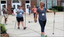  ?? MICHILEA PATTERSON — DIGITAL FIRST MEDIA ?? People try Nordic walking for the first time during the “Healthy Bodies, Healthy Minds Institute” held at the Pottstown Middle School.