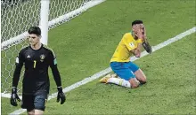  ?? THANASSIS STAVRAKIS THE ASSOCIATED PRESS ?? Brazil’s Neymar reacts next to Belgium goalkeeper Thibaut Courtois, left, during the quarter-final match. Brazil lost the contest, 2-1.