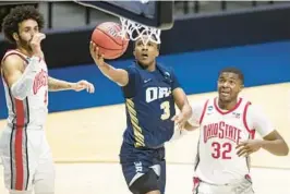  ?? ROBERT FRANKLIN/AP ?? Oral Roberts’ Max Abmas burst onto the scene in 2021 when he averaged 26.7 points in three NCAA Tournament games to help Oral Roberts beat Ohio State and Florida before falling to Arkansas in the Sweet 16.