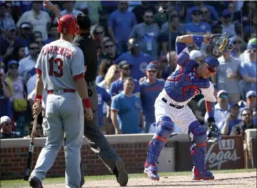  ?? CHARLES REX ARBOGAST — THE ASSOCIATED PRESS ?? Chicago Cubs catcher Willson Contreras, right, slams his mask down as home plate umpire Jordan Baker tosses him out of the game while St. Louis Cardinals’ Matt Carpenter watches during the fifth inning of a baseball game Friday in Chicago.