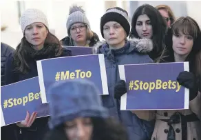  ?? PHOTO: GETTY IMAGES ?? Activists hold signs about a Title IX lawsuit in January outside the US Department of Education. ‘Betsy’ is US Education Secretary Betsy de Vos whom they accuse of diluting victims’ rights