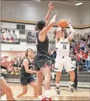  ??  ?? Calhoun Junior Brendan Gray puts up a two point shot early in Calhoun’s game against Sonoravill­e Saturday. The Jackets handed the Phoenix their first loss of the season 55-28.