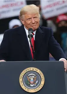  ?? NANcy lANE / HErAld sTAFF FIlE ?? I DID IT MY WAY: President Trump wears a cryptic grin during a campaign stop on Oct. 25 in Londonderr­y, N.H. He went on to lose the election, but he won many people’s hearts. The Herald endorsed Trump for president.