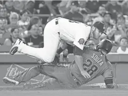  ??  ?? The Diamondbac­ks’ Steven Souza Jr. slides into Dodgers third baseman Max Muncy on a steal attempt Tuesday.