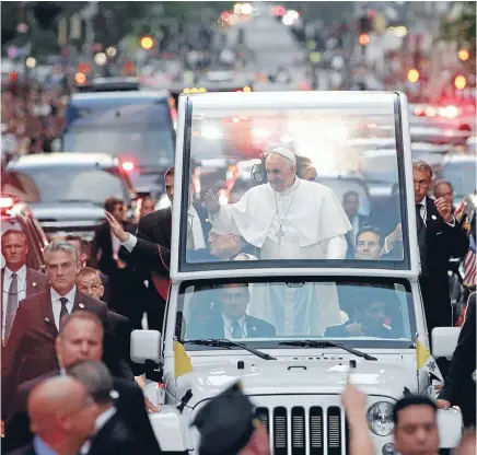  ?? Photo: REUTERS ?? Pope Francis waves to the crowds as he is driven down Fifth Avenue in the Popemobile at the start of his visit to New York.